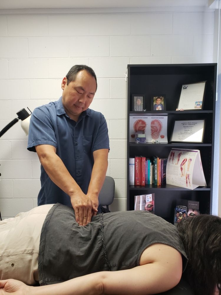 Anthony Pape treating a patient in his Oakland office